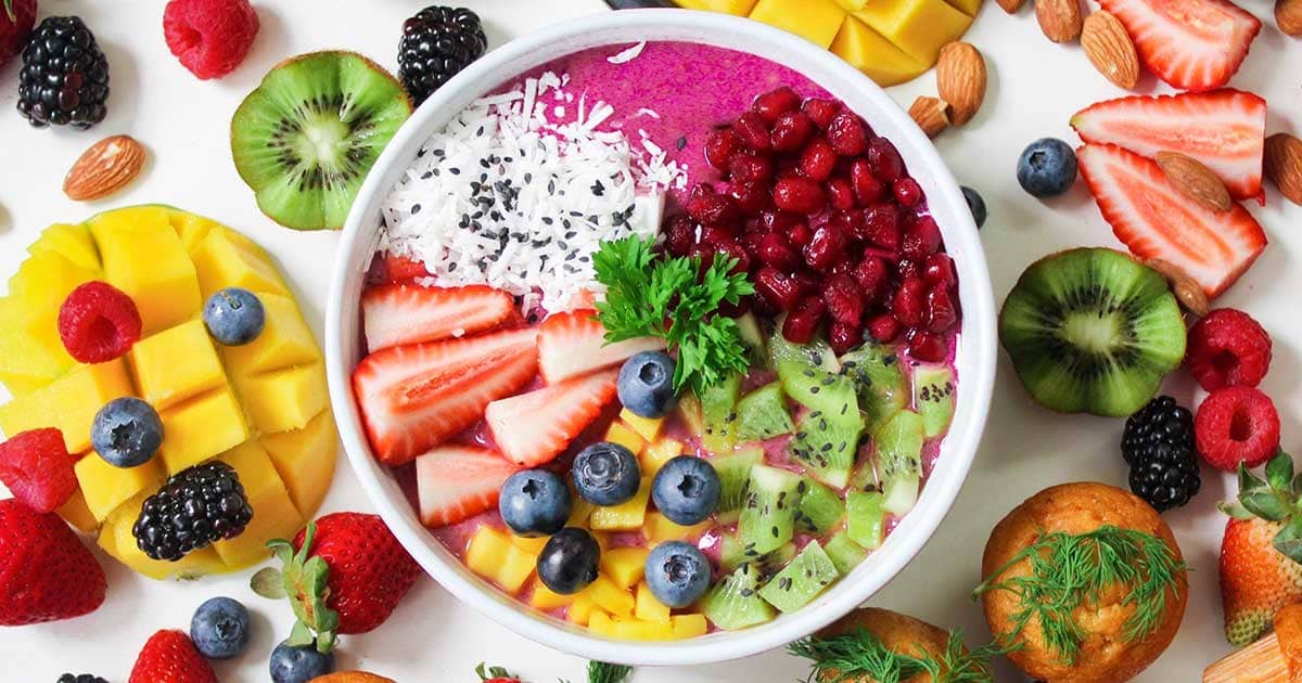 Smoothies of the Soul: A vibrant smoothie bowl topped with fresh fruits, berries, and nuts, surrounded by a serene and calming setup.